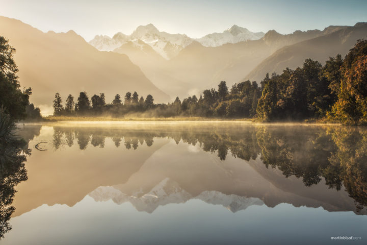 A perfect reflection at Lake Matheson. In the background are two highest peaks of New Zealand - Mount Cooc and Mount Tasman